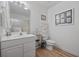 Clean, well-lit bathroom with white vanity, updated fixtures, and decorative nautical themed accessories at 304 62Nd Ave N 62Nd Ave. N, North Myrtle Beach, SC 29582