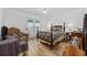 Spacious bedroom with hardwood floors, patio access, and cozy wicker furnishings at 304 62Nd Ave N 62Nd Ave. N, North Myrtle Beach, SC 29582