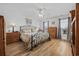 Well-lit bedroom with hardwood floors, a ceiling fan, and a large bed with nightstands at 304 62Nd Ave N 62Nd Ave. N, North Myrtle Beach, SC 29582