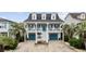 Charming coastal home boasts a double porch, blue shutters, and well-maintained landscaping with palm trees at 304 62Nd Ave N 62Nd Ave. N, North Myrtle Beach, SC 29582