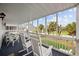 Screened-in porch with rocking chairs overlooking a lush, tropical backyard at 304 62Nd Ave N 62Nd Ave. N, North Myrtle Beach, SC 29582