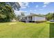 A well-maintained, grassy backyard with a deck on a charming single-story home at 3537 Lighthouse Way, Myrtle Beach, SC 29577