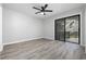 Bright bedroom featuring wood-look flooring, a ceiling fan, closet space, and a sliding glass door to a balcony at 3537 Lighthouse Way, Myrtle Beach, SC 29577