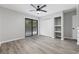 Bright bedroom featuring wood-look flooring, a ceiling fan, closet space, and a sliding glass door to a balcony at 3537 Lighthouse Way, Myrtle Beach, SC 29577