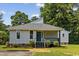 Charming single-story home featuring a teal front door, mature trees, and a well-maintained lawn at 3537 Lighthouse Way, Myrtle Beach, SC 29577