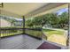 Inviting covered front porch with wood railings and lush green surroundings at 3537 Lighthouse Way, Myrtle Beach, SC 29577