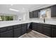 Modern kitchen showcasing gray cabinets, white countertops, and stainless steel appliances, with natural light at 3537 Lighthouse Way, Myrtle Beach, SC 29577