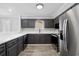 Modern kitchen features dark cabinets, white countertops and stainless steel appliances for a sleek look at 3537 Lighthouse Way, Myrtle Beach, SC 29577