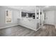 Bright kitchen view with gray cabinets, breakfast bar, open floor plan, and hardwood style flooring at 3537 Lighthouse Way, Myrtle Beach, SC 29577