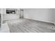 Spacious living room featuring gray wood floors with an open layout to the kitchen at 3537 Lighthouse Way, Myrtle Beach, SC 29577