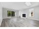 Bright living room with hardwood floors, fireplace, sliding glass doors, and a skylight at 3537 Lighthouse Way, Myrtle Beach, SC 29577