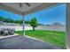 Covered patio that looks out onto a large, fenced backyard with a tree and green grass at 365 Lenox Dr., Conway, SC 29526