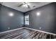 This bedroom features sleek wood floors, a ceiling fan, and a bright window, making it feel modern and inviting at 365 Lenox Dr., Conway, SC 29526