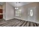 Charming dining area with modern wood flooring, bright window, and an elegant chandelier, perfect for Gathering meals at 365 Lenox Dr., Conway, SC 29526