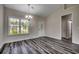 Cozy dining area featuring hardwood-style flooring, elegant chandelier, and ample natural light from the large window at 365 Lenox Dr., Conway, SC 29526