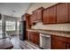 This kitchen features dark wood cabinetry, stainless steel appliances, and hardwood flooring at 365 Lenox Dr., Conway, SC 29526