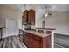 Well-appointed kitchen featuring dark wood cabinetry, stainless steel appliances, and a convenient breakfast bar overlooking the living area at 365 Lenox Dr., Conway, SC 29526