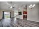 Spacious living room featuring modern plank floors, ceiling fan, recessed lighting, and sliding glass doors to backyard at 365 Lenox Dr., Conway, SC 29526