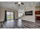 Bright living room boasting plank floors, vaulted ceiling, large windows, and seamless flow to the dining area and kitchen at 365 Lenox Dr., Conway, SC 29526