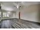 Inviting living room featuring wood-look flooring, ceiling fan, and large windows that flood the space with natural light at 365 Lenox Dr., Conway, SC 29526