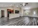 Open-concept living area with modern plank flooring, high ceilings, and a seamless transition to the kitchen and dining area at 365 Lenox Dr., Conway, SC 29526