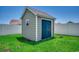 Exterior view of a shed on a grassy lawn with double doors, a window, and a white fence at 365 Lenox Dr., Conway, SC 29526