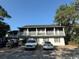 Two-story home with a gray exterior, white trim, and parking at 403 71St Ave. N # 14, Myrtle Beach, SC 29575