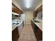 Galley kitchen with white appliances and dark cabinets at 403 71St Ave. N # 14, Myrtle Beach, SC 29575