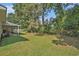 Large backyard with a mix of open lawn and wooded areas, providing a private retreat at 424 Villa Woods Dr., Myrtle Beach, SC 29579