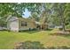 Sprawling backyard with lush green lawn and mature trees, ideal for outdoor activities at 424 Villa Woods Dr., Myrtle Beach, SC 29579