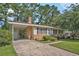 Charming single-story home featuring a brick facade, cozy carport, and a well-maintained front yard at 424 Villa Woods Dr., Myrtle Beach, SC 29579