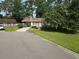 Charming single-story home with a well-maintained front lawn and mature shade tree at 424 Villa Woods Dr., Myrtle Beach, SC 29579