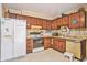 Traditional kitchen with wood cabinets, appliances, and ample counter space at 424 Villa Woods Dr., Myrtle Beach, SC 29579