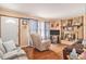 Cozy living room boasts a brick fireplace, wood floors, and comfortable seating at 424 Villa Woods Dr., Myrtle Beach, SC 29579