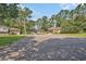 Residential street featuring well-spaced homes with mature trees and landscaped yards at 424 Villa Woods Dr., Myrtle Beach, SC 29579