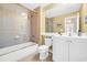 Bright bathroom featuring a shower-tub combo with glass doors, a white vanity and a large mirror at 431 Huntington Lake Circle # 80, Pawleys Island, SC 29585