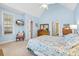 Bright bedroom with floral bedding, light blue walls, and natural light from a window at 431 Huntington Lake Circle # 80, Pawleys Island, SC 29585