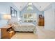 Comfortable bedroom featuring a vaulted ceiling, large window, and neutral color scheme at 431 Huntington Lake Circle # 80, Pawleys Island, SC 29585