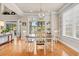 Bright dining room with hardwood floors, chandelier, and sliding glass doors to the outdoor living area at 431 Huntington Lake Circle # 80, Pawleys Island, SC 29585