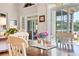Close up on the dining room table with flowers overlooking the porch and lake at 431 Huntington Lake Circle # 80, Pawleys Island, SC 29585