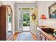 Welcoming entryway features a bright front door with a wreath, hardwood floors, and elegant furniture accents at 431 Huntington Lake Circle # 80, Pawleys Island, SC 29585