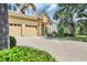 Inviting two-story home boasts a double garage, well-kept lawn, and yellow exterior with a decorative front entrance at 431 Huntington Lake Circle # 80, Pawleys Island, SC 29585