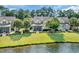 Exterior backyard view of home featuring lawn to lake views at 431 Huntington Lake Circle # 80, Pawleys Island, SC 29585