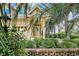 Charming home exterior featuring a well-manicured lawn and a welcoming front entrance with a yellow door and beautiful foliage at 431 Huntington Lake Circle # 80, Pawleys Island, SC 29585