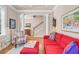 Inviting living room showcases a vibrant red sofa, patterned chairs, and a staircase, all on gleaming hardwood floors at 431 Huntington Lake Circle # 80, Pawleys Island, SC 29585