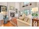 Spacious living room featuring a fireplace, built-in shelving, and large windows with a lake view at 431 Huntington Lake Circle # 80, Pawleys Island, SC 29585