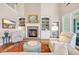 Living room with brick fireplace, built-in shelving, and natural light at 431 Huntington Lake Circle # 80, Pawleys Island, SC 29585