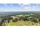 Aerial view of a single-Gathering home surrounded by trees and lush greenery with a beautiful sky at 4446 Boggy Rd., Conway, SC 29526