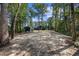 Exterior view of backyard featuring a home and an outbuilding, surrounded by trees at 4446 Boggy Rd., Conway, SC 29526