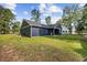 Back exterior of home featuring dark siding and a sprawling yard at 4446 Boggy Rd., Conway, SC 29526